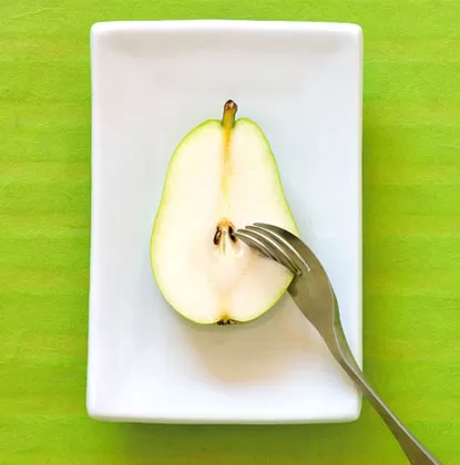 Knork fork and knife in one cutting an apple