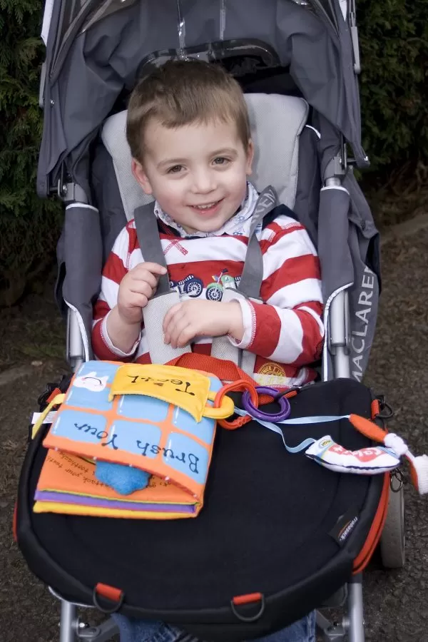 Trabasack Curve Connect wheelchair lap tray and bag on a disabled child's lap