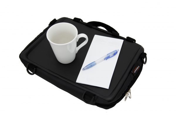 Trabasack Mini wheelchair lap tray and bag with pen, paper and mug on top