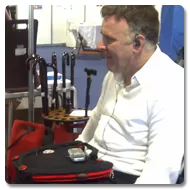 Man in a wheelchair using Trabasack Curve Connect wheelchair lap tray and bag