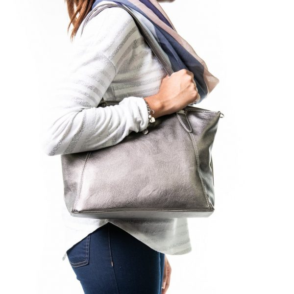 Sam Renke's silver handbag on a woman's shoulder