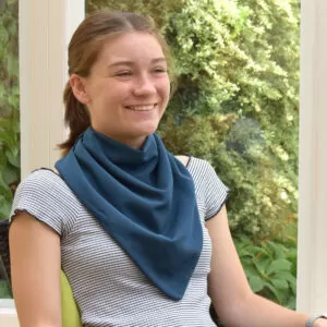 girl smiling wearing the long adult neckerchief in steel blue
