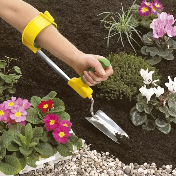 Easi-Grip cuff for garden tools being used in flower bed with garden trowel