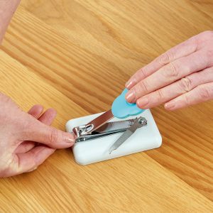 Peta Easi-Grip table-top nail clippers cutting finger nails as it's being pressed down