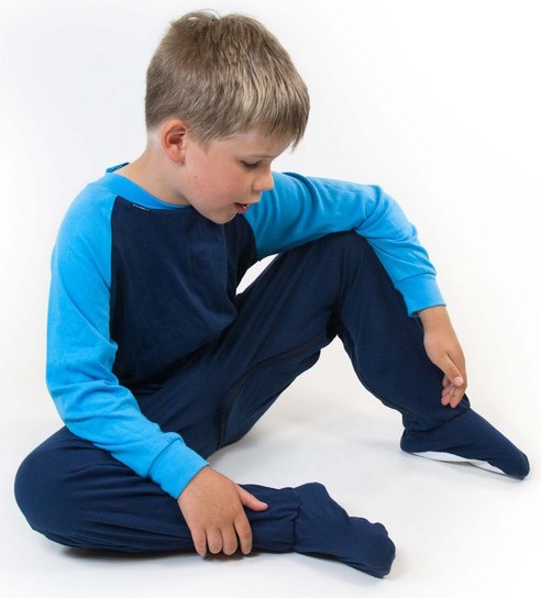 Young boy sat down wearing Seenin children's turquoise and navy zip sleepsuit