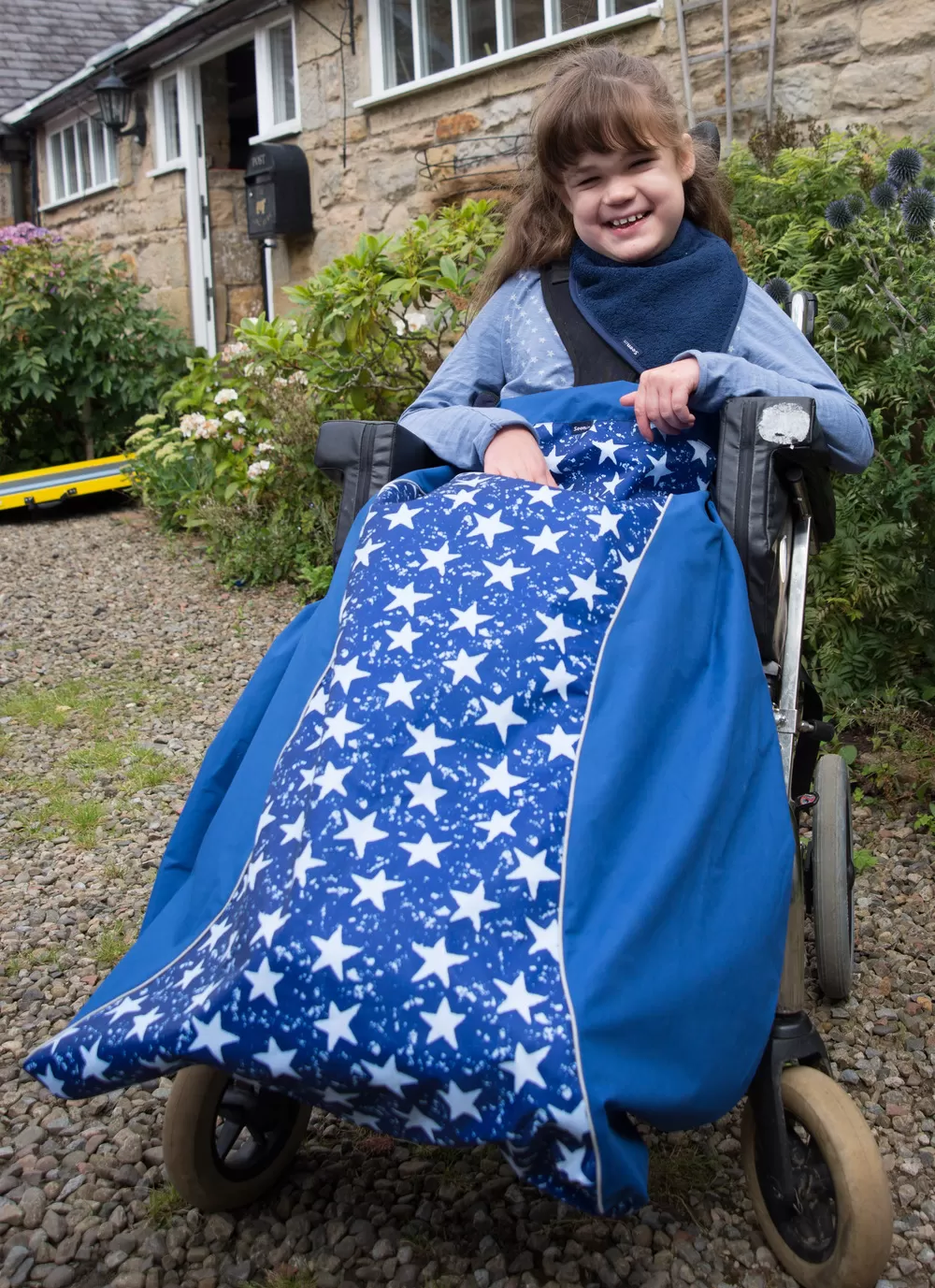 Disabled girl in navy star print Seenin waterproof wheelchair leg cover