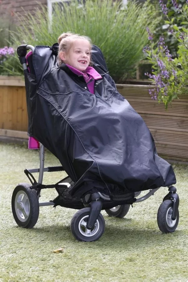 Disabled girl wearing black Seenin total waterproof wheelchair cover