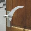 Image shows an internal wooden house door with the plastic Tru Grip door handle extender installed