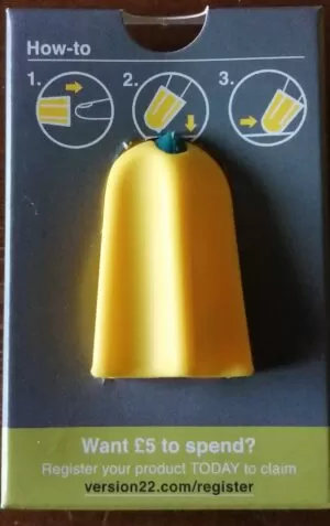 Yellow cone shaped Nimble one finger cutter with ridges in it and a blue sharp tip sat in a blue box with images showing you how to use it by putting it on your finger