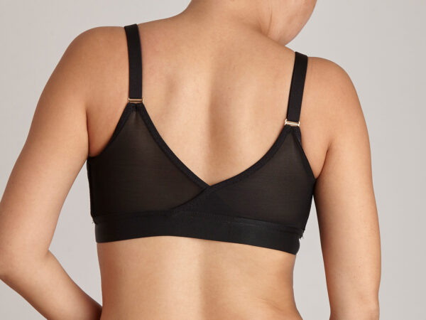 Image is a back view of a lady wearing an Elba London front-fastening, magnetic, adaptive bra in black