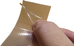 Cat Tongue nonabrasive grip tape being peeled off its backing