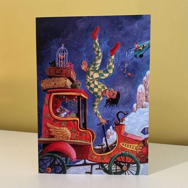 Image is a photograph of a christmas card by Peter Rodulfo featuring a red, winged fantasy car being jocularly driven by a harlequin-type character, in a winter-like land