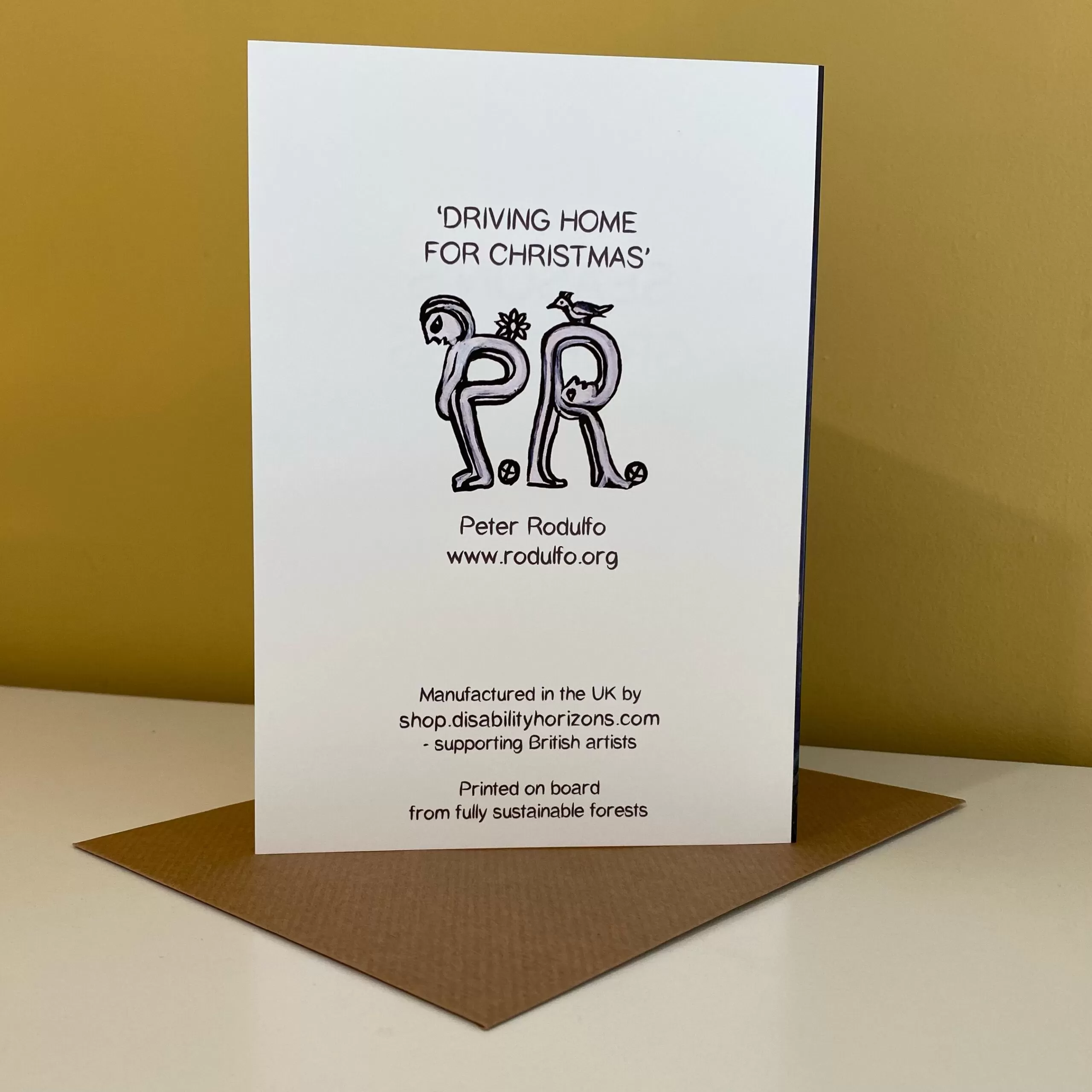 Image is a photograph of the back of a Peter Rodulfo Christmas card entitled "Driving Home for Christmas"