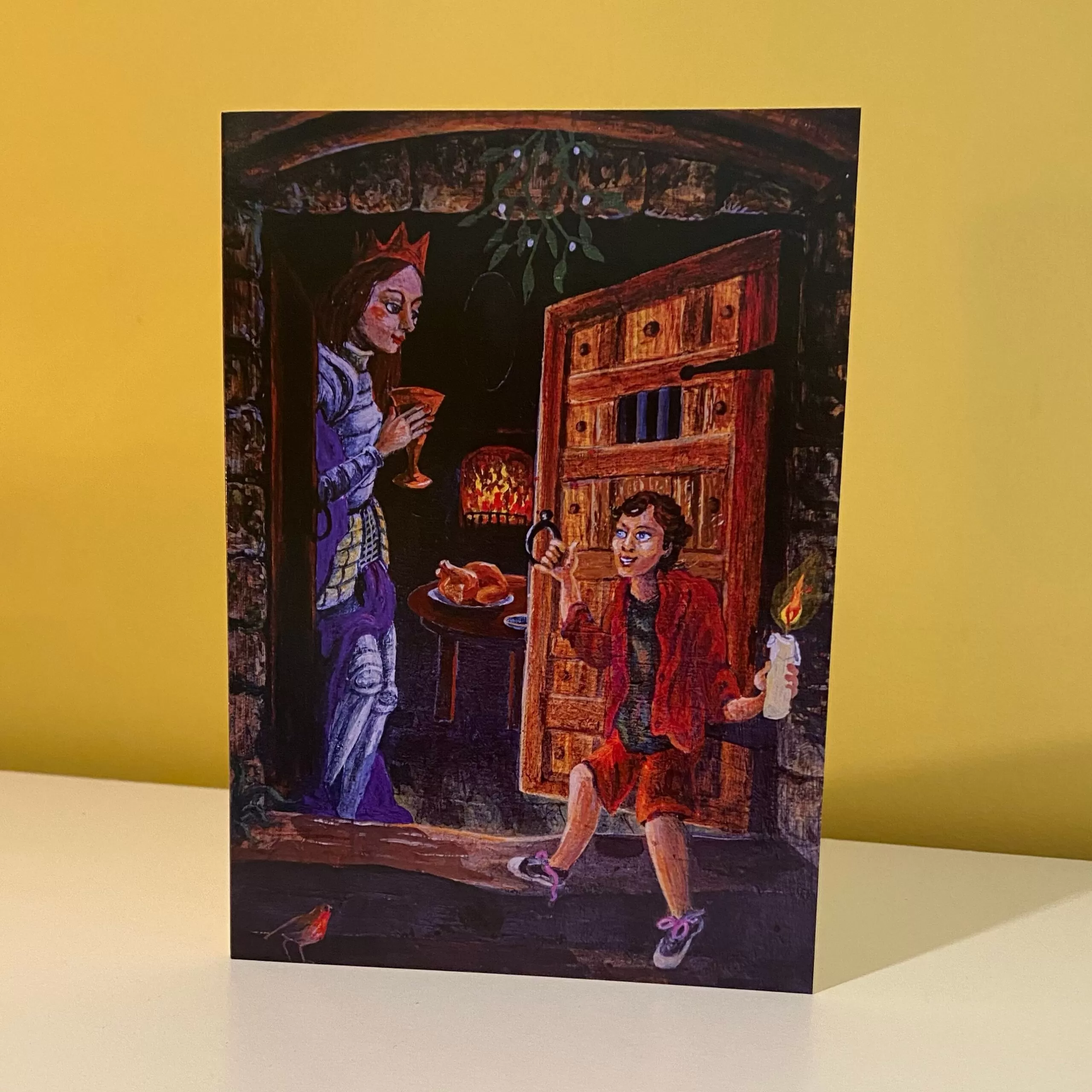 Image is a photograph of a Peter Rodulfo christmas card entitled "Welcome" featuring a medieval-style regal lady welcoming a young man holding a candle, through a large, ornate wooden door.