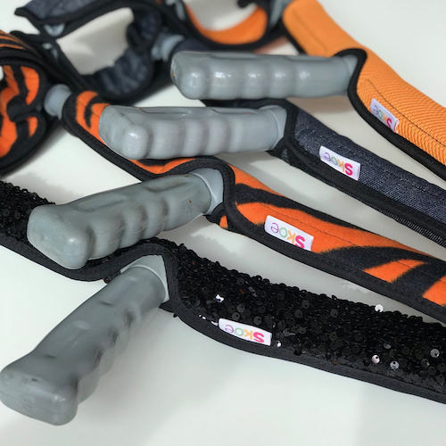 Four Skoe stylish crutch covers on crutches - black sequins, orange and black striped, orange and denim