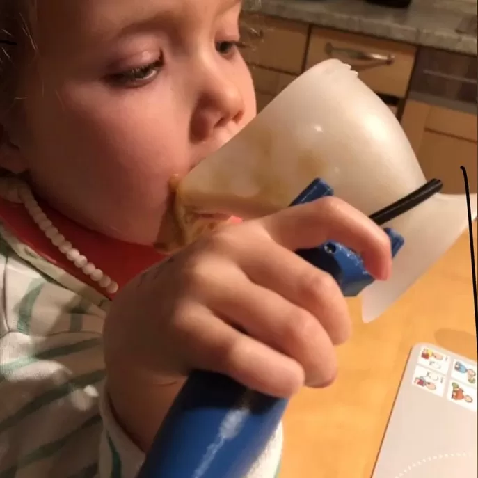functionalhand being used to drink a smoothie from a mug