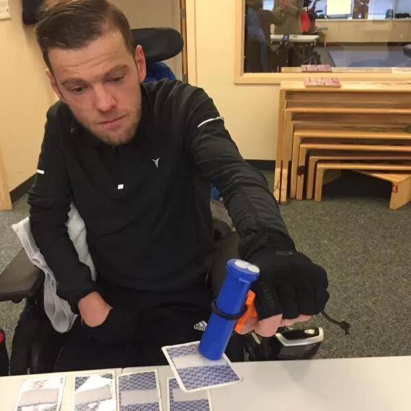 man playing cards with the functionalhand and some velcro