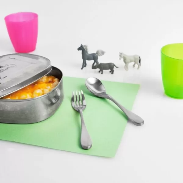 picture showing the knork childs set center with a dish to the right surronded by child drinking beakers and toy horses