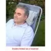 man using the cushion as a headrest on a garden chair "double-folded as a headrest"