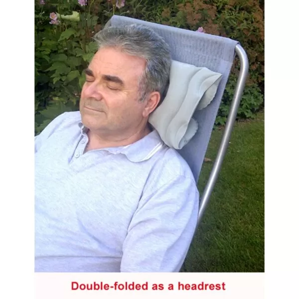 man using the cushion as a headrest on a garden chair "double-folded as a headrest"