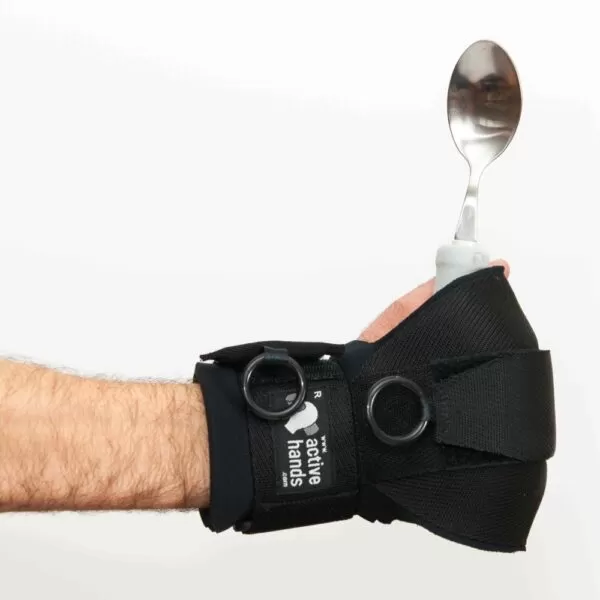 active hands general purpose gripping aid holding a spoon