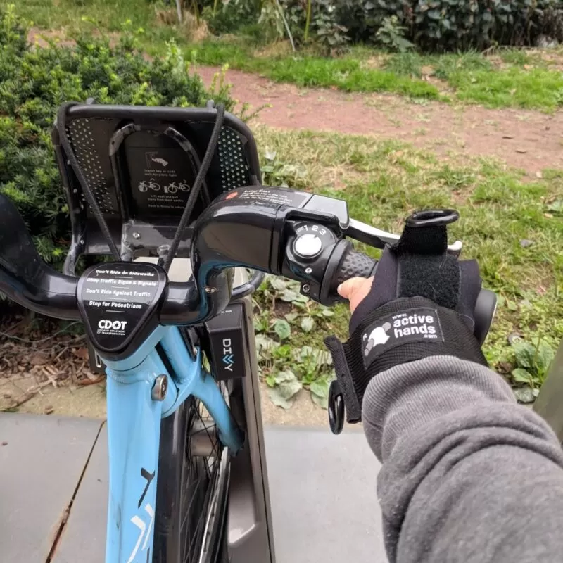 Image showing the limb difference aid being used to grip a motorbike handle