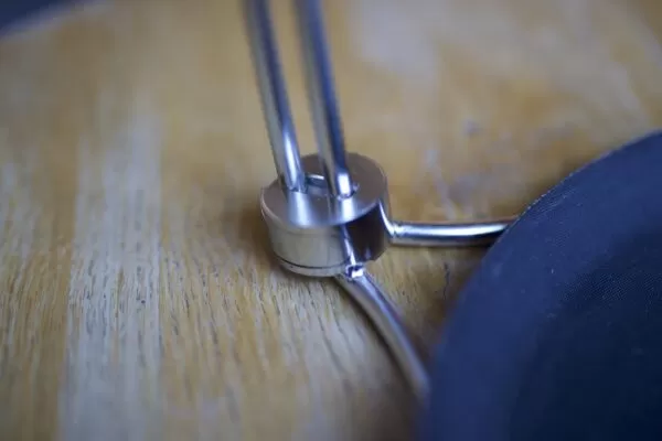 Image showing the tipsi tray connection point a top a oak wood coloured table.