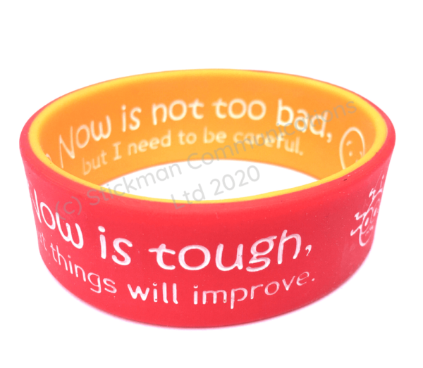 Stick Man communications symptom wristband showing the amber "now is tough" side