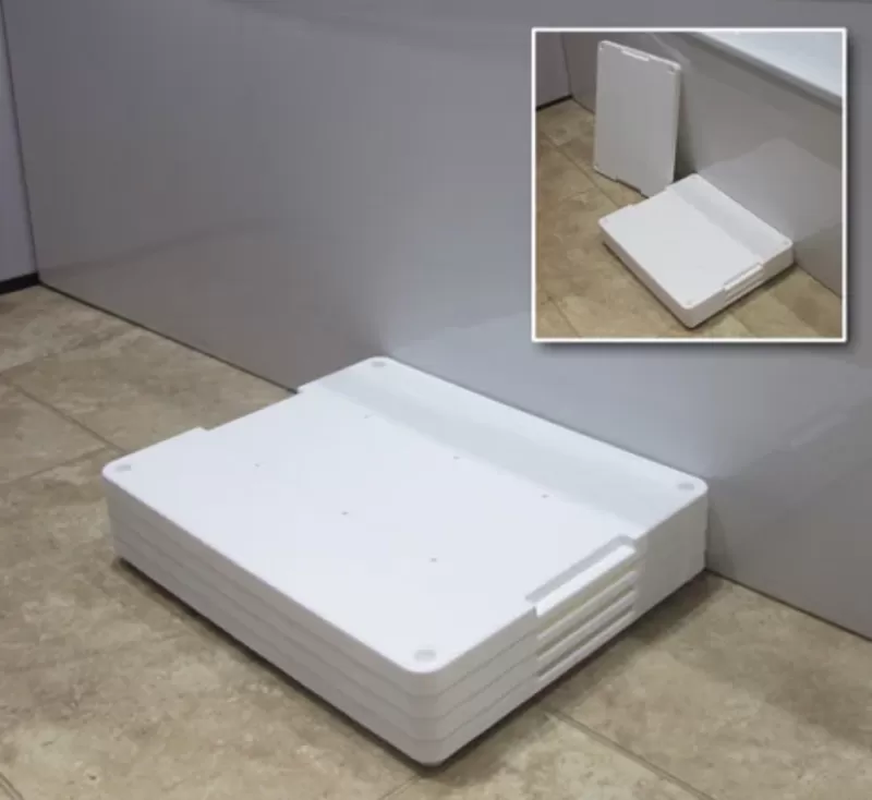 White plastic bath step next to a bath