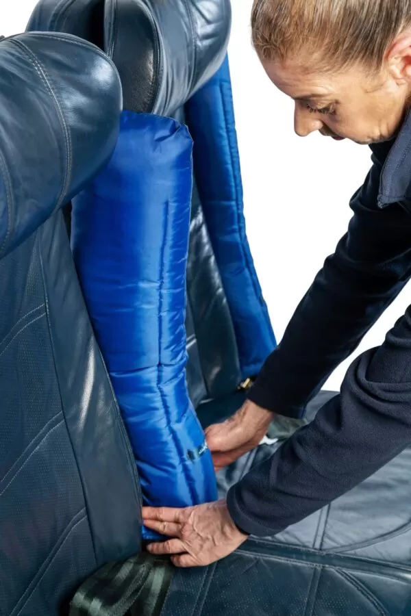the blue padded arm rest facing upright on an airplane seat