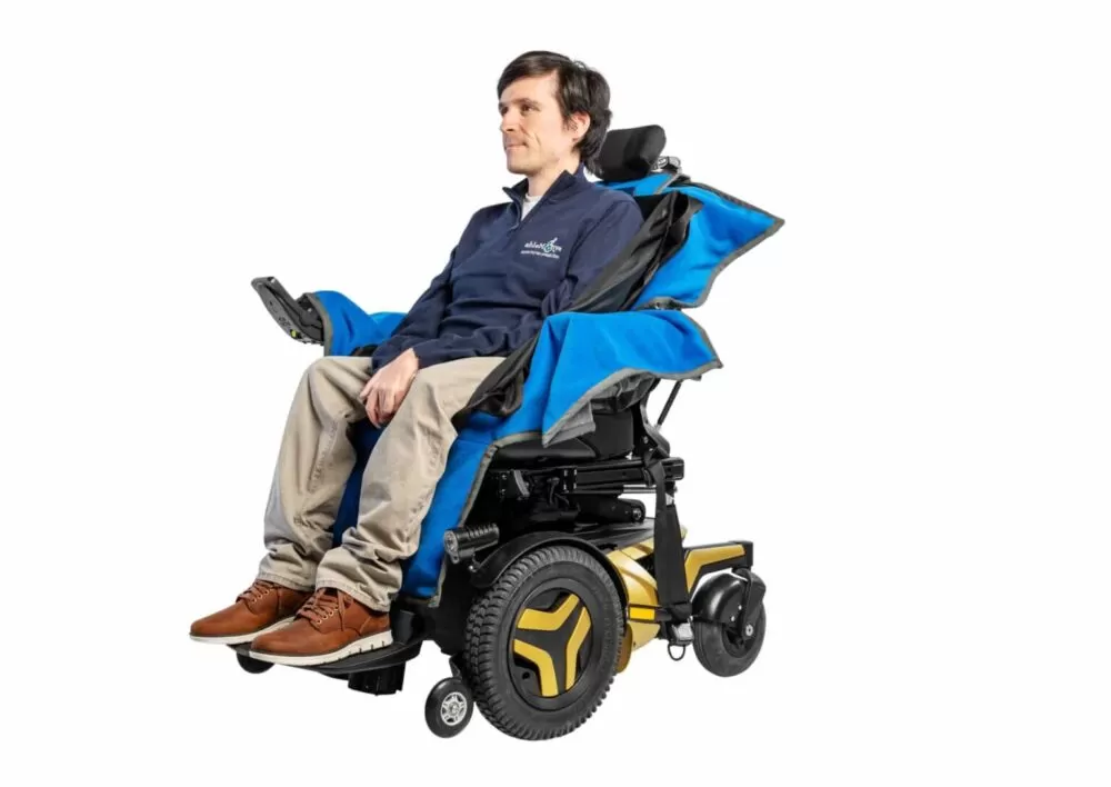 a man sitting in the electric wheelchair with the able dry cover on