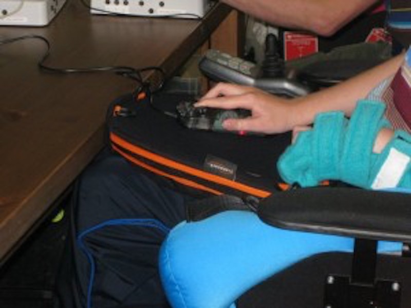 Trabasack is being used for a gaming console. Attached with side straps at the armrests.