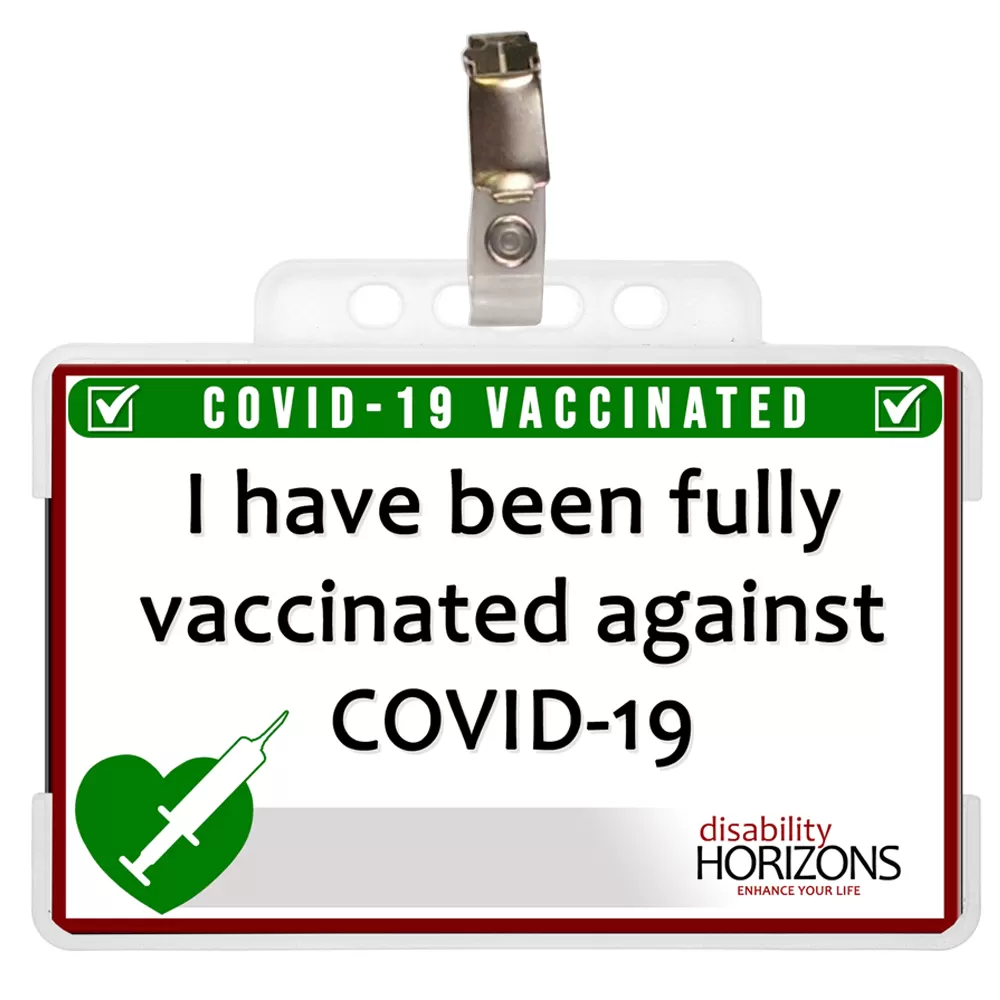 Image shows the "I have been fully vaccinated" Disability Horizons ID card in a plastic card holder, with a badge clip attached to the top