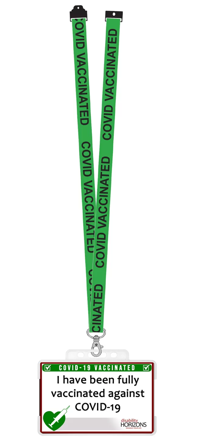 Image is the Disability Horizons shop Covid-19 vaccination ID card in a plastic card holder, with a green lanyard attached to the top, with white writing which reads "COVID VACCINATED"