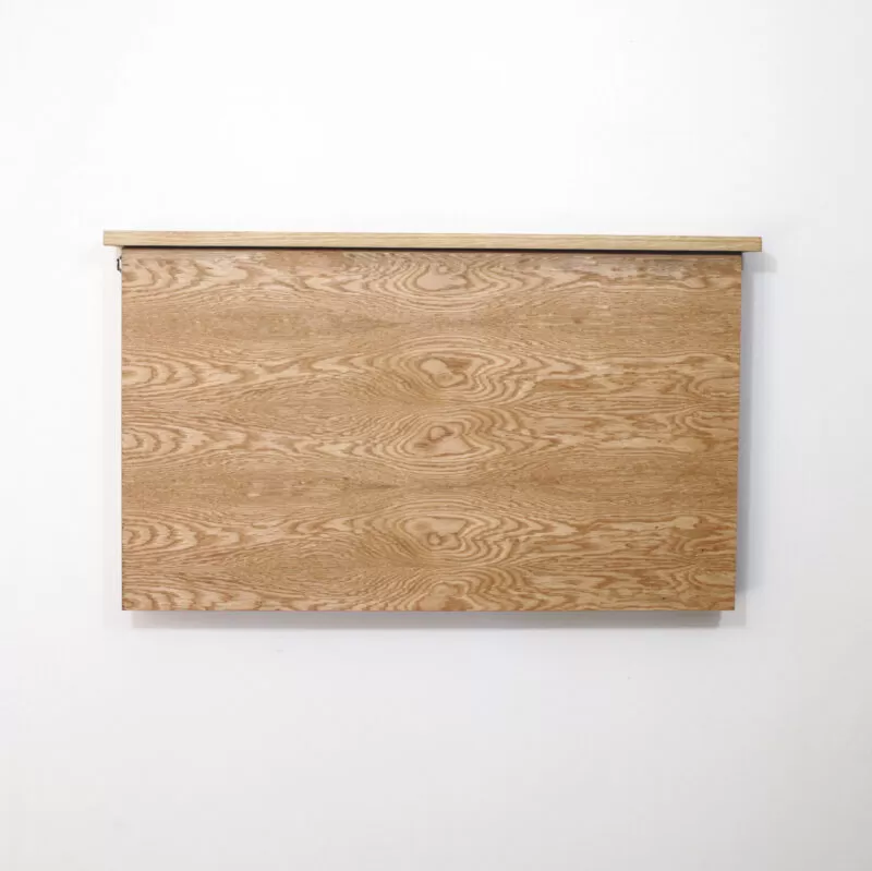 height adjustable desk closed and mounted to the wall