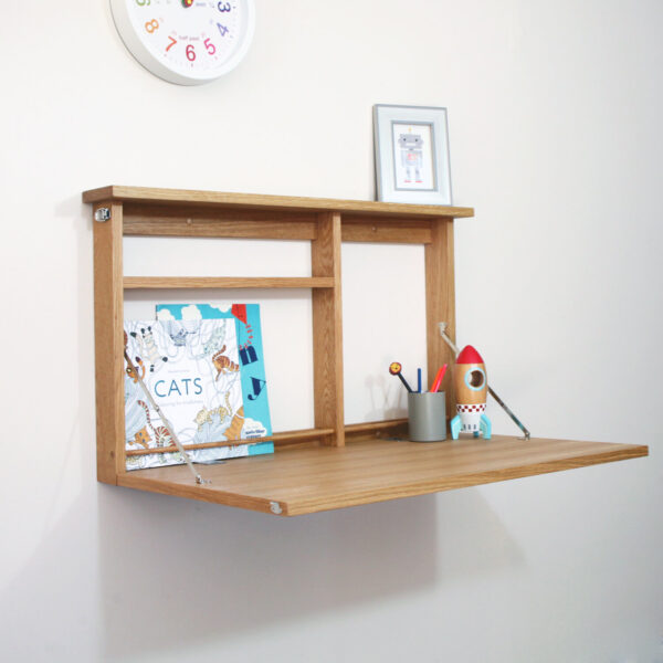 griffin and sinclair height adjustable desk set up with kids items on.