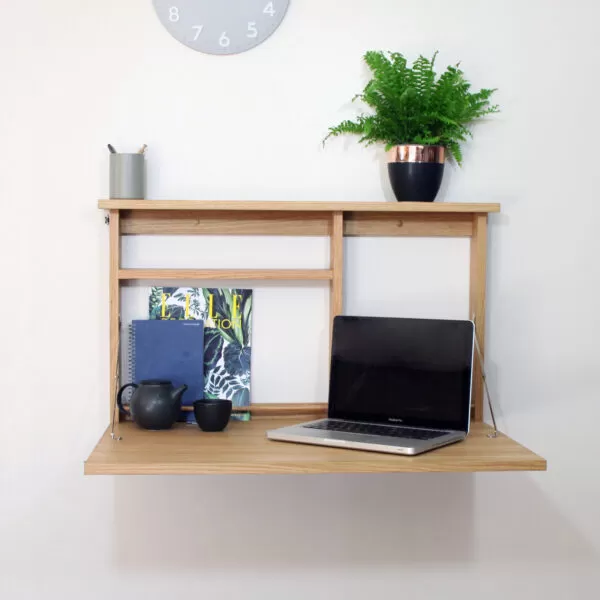 Griffin and sinclair height adjustable desk with a laptop open on top of the desk.