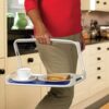 women carrying the freetray to her side with a sandwhich and cup of tea on