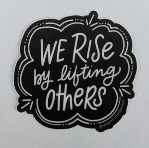 we rise by lifting others on white paper