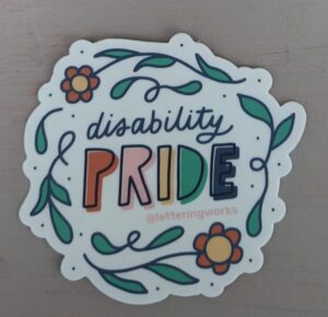 disability pride sticker. white background with flower border and PRIDE written multi-coloured