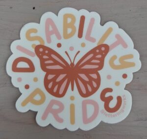 disability pride butterfly sticker. disability pride written in prink, orange and pink around the border. orange butterfly in the middle
