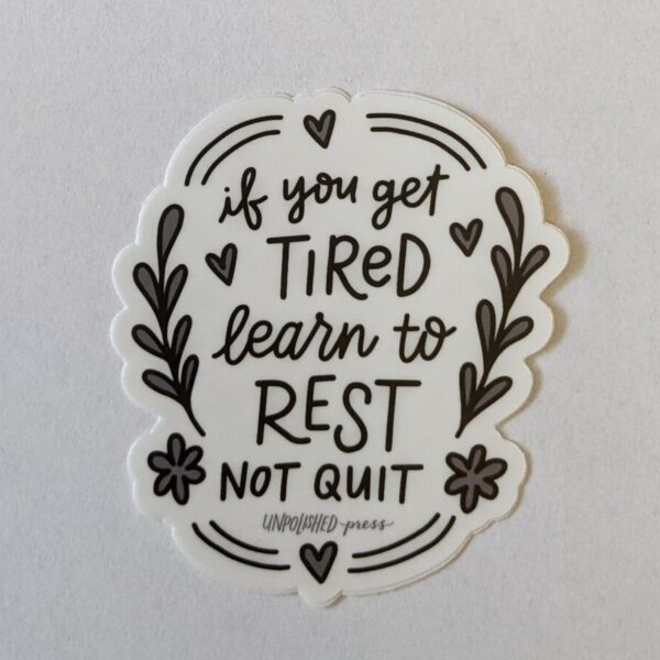 if you get tired learn to rest not quit. in black text on white background sticker. black artsy flowers around the border
