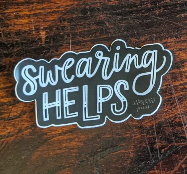 swearing helps sticker on wooden table