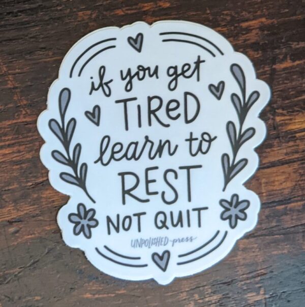 learn to rest sticker on a wooden table