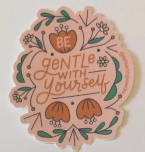 be gentle with yourself sticker on a white table