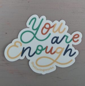 you are enough sticker on white table