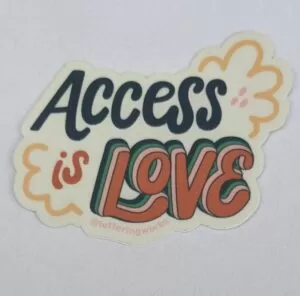 access is love sticker on white paper. white cloud design with LOVE written in a chubby red font