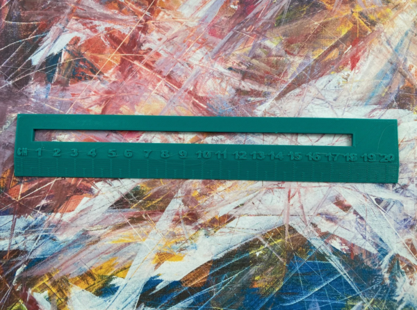 green dyslexia aid ruler on a coloured background
