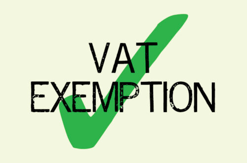 The words VAT exemption in black capital letters with a big green tick behind them