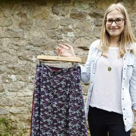 Katie Ellis holding clothing